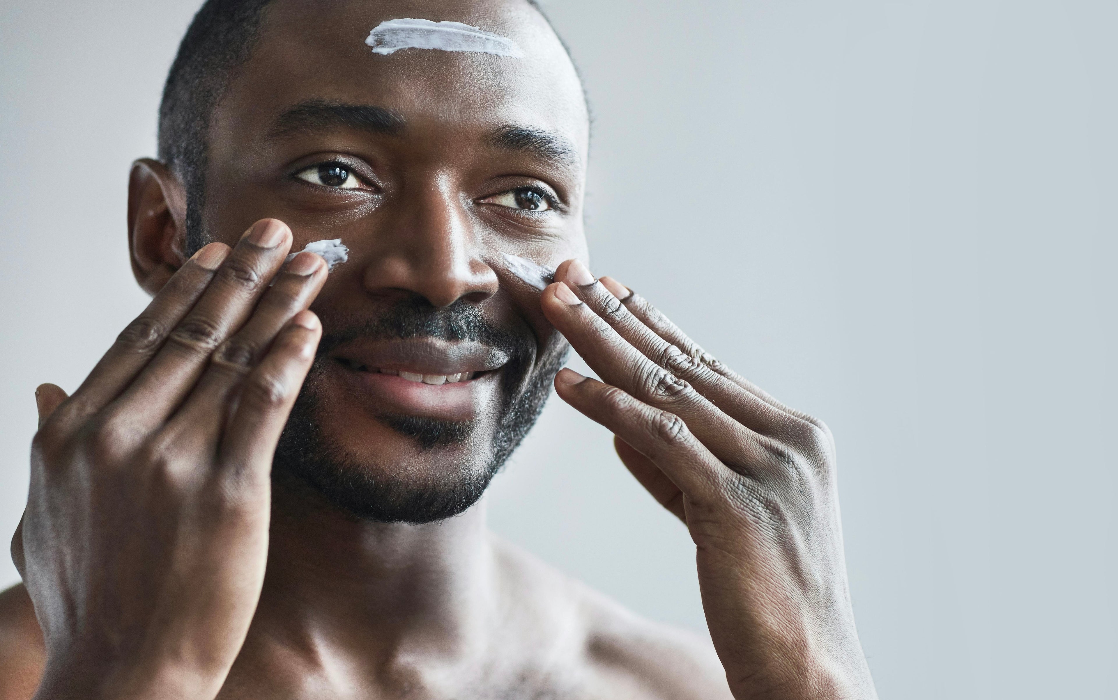 Man applying cream to face